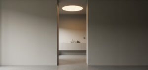 Minimalist badrum med taklampa och jämnt ljus för allmän belysning.