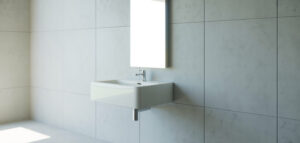 Minimalist badrum med vit kommod och handfat i ljusa toner.