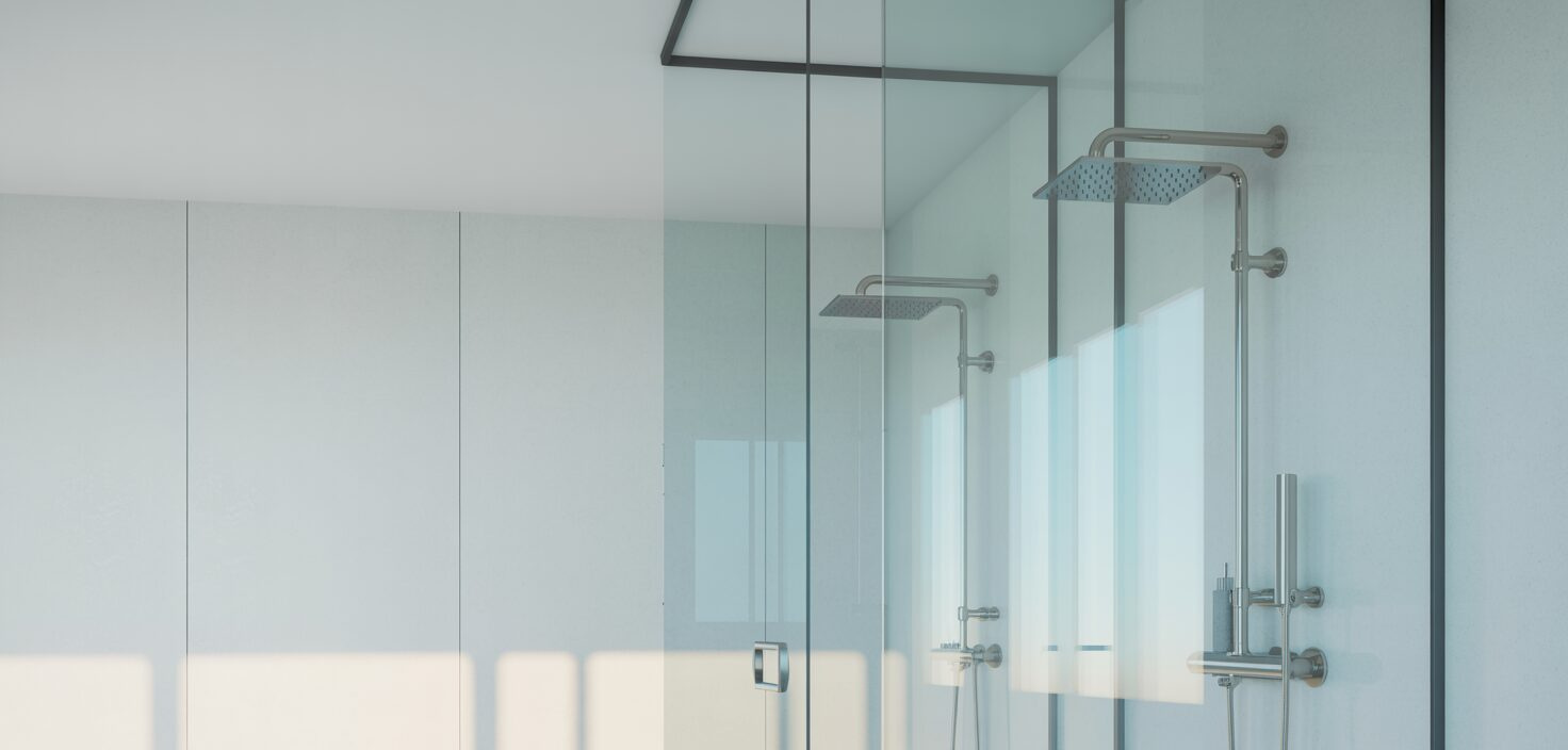 Modernt badrum med glasvägg, minimalistisk design och rent utseende.