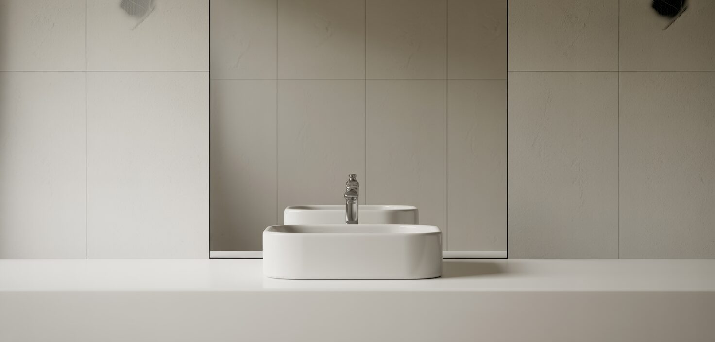 Modernt badrum med minimalistisk design och vit tvättställ.